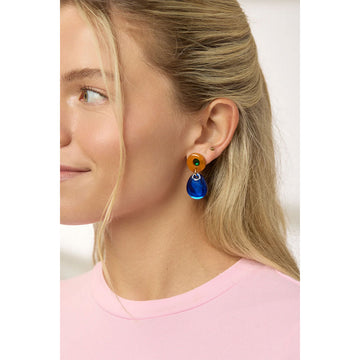A pair of drop earrings in brown and blue.