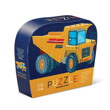 A puzzle box in dark blue with an illustration of a construction truck in yellow on the front.
