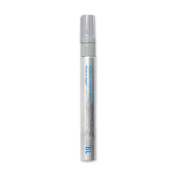 A thick silver marker with blue text on it.