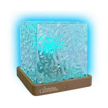 A blue glowing cube light on a tan base with Australian Geographic branding.