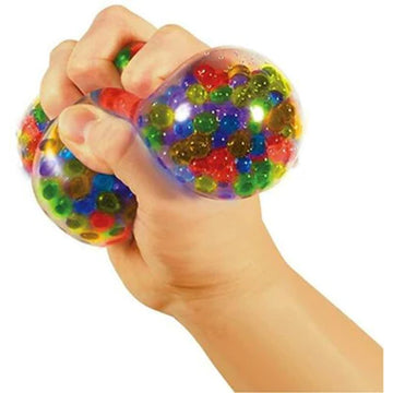A stress ball inside a cube box with the text 'Squeezy Peezy Nee Doh' written on the front.