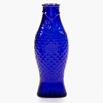 A dark blue glass carafe shaped like a fish.