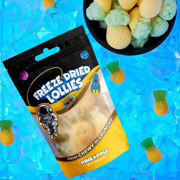 A packet of lollies with the heading 'Freeze Dried Lollies' next to a bowl of pineapple lollies.