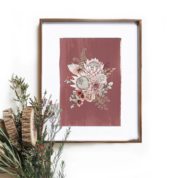 An illustation of a king protea on a terracotta background in a gold frame. There is a small bouquet in front.