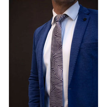 A men's tie printed with a line design in dark blue and white.