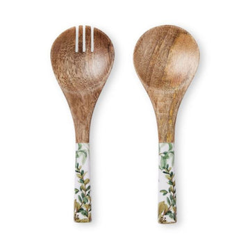 An image of a set of wooden salad servers with a white and green image of leaves on the handles.