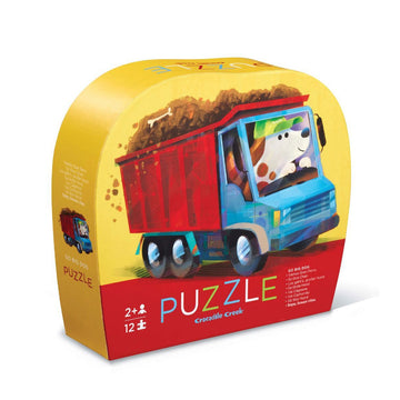 Puzzle box with a colorful illustration of a dog driving a truck on a white background.