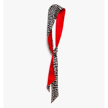 A twilly silk scarf with red on one side and a black and white pattern on the other. 
