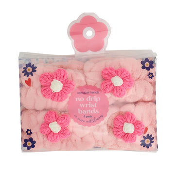 Two pairs of pink wrist bands with pink flowers inside a clear box.