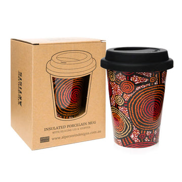Insulated porcelain mug with Aboriginal design next to its packaging box on a white background.