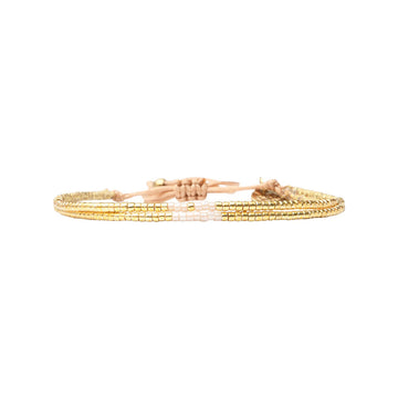 Gold beaded bracelet on a white background.