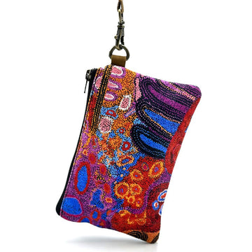 Colourful printed pouch with a black zip and wrist strap.