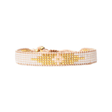 Beaded bracelet with gold and white beads on a white background.