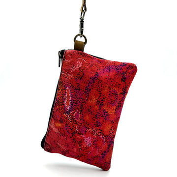 Red and black patterned pouch with a black zipper on a white background.