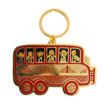 An enamel keyring shaped like a bus with people inside.