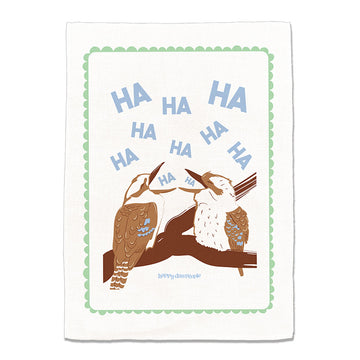Tea towel with two kookaburras on a branch and 'HA HA HA' text, brand 'Happy Day People' visible.