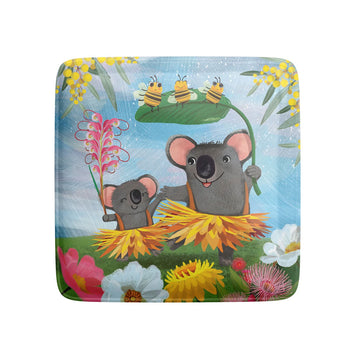 A square magnet illustrated with two koalas wearing grass skirts and surrounded by flowers and bees.*