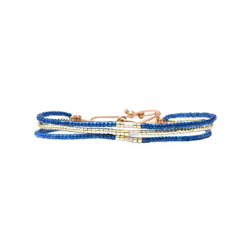 Set of three beaded bracelets in blue, and gold on a white background.