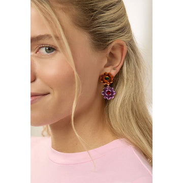 Colorful flower-shaped earrings with gemstones on a light gray background