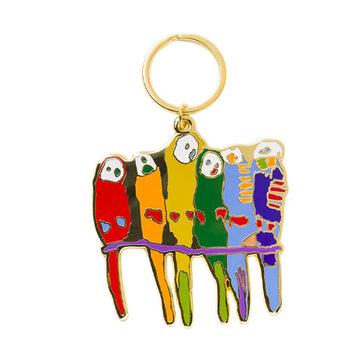 An enamel keyring shaped like six different colourful birds sitting on a branch.