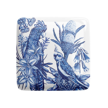 A square magnet illustrated with birds and flowers in blue and white.