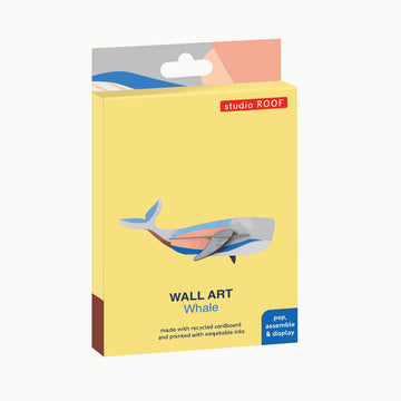 Coloured cardboard model of a whale on a white background.