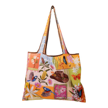 A reusable shopping bag illustrated with a collage of flowers, birds and a cowboy hat.