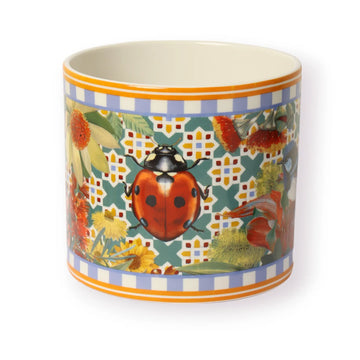 A round planter illustrated with a ladybug and flowers.
