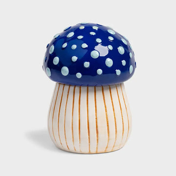 Mushroom-shaped jar with blue polka dot cap and striped white and gold stem on a light gray background.