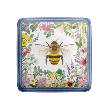 A square magnet illustrated with a bee and a border of flowers.