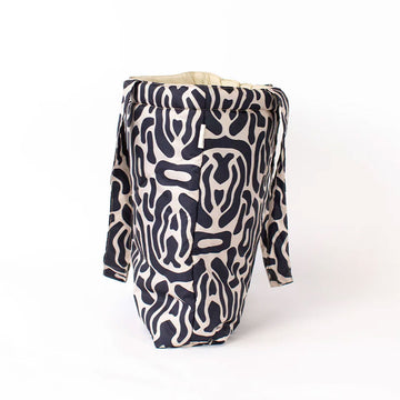 Patterned black and cream tote bag on a white background.