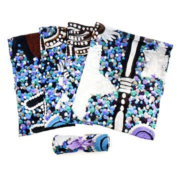 A baby swaddle pictured and printed with artwork by Cedric Varcoe. There is another swaddle rolled up.