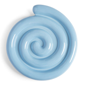 Light blue ceramic trivet with a spiral design on a white background