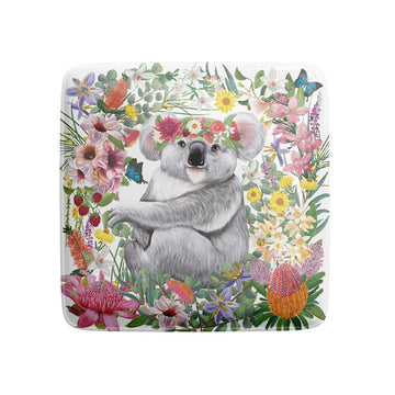 A square magnet illustrated with a koala wearing a flower crown surrounded by flowers.