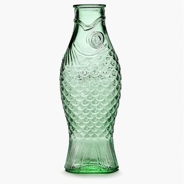 A green glass carafe shaped like a fish.