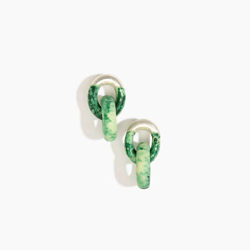 A pair of earringss made up of two hoops intertwined made from green resin. 