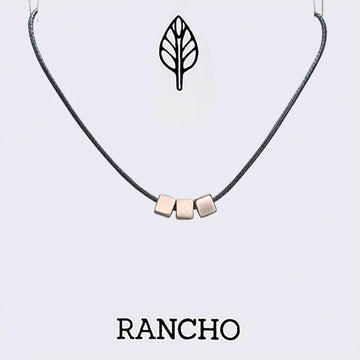 Necklace with three silver cube pendants on a white background with 'RANCHO' branding.