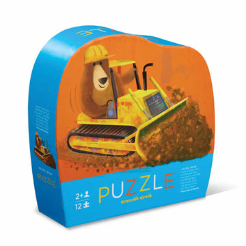 Puzzle box with a cartoon bulldozer and bear character on an orange and blue background.