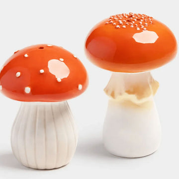 Two mushroom-shaped salt and pepper shakers on a white background.