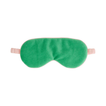Front view of a velvet eye mask in green with a light pink satin strap.
