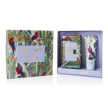 Gift set with a soap and hand cream featuring parrot and leaf design on a white background.