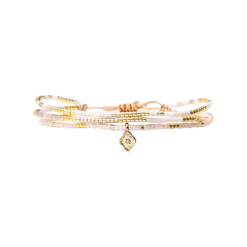 Multistrand beaded bracelet with a diamond-shaped charm on a white background.
