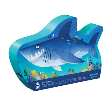A puzzle box in the shape of a shark with an illustration of a shark on the front.