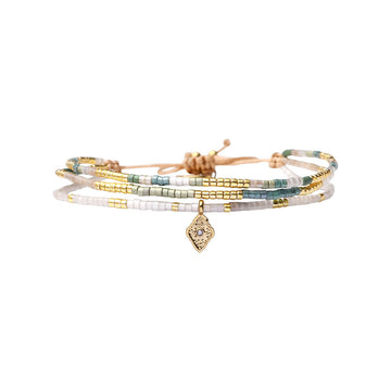 Set of beaded bracelets with a pendant on a white background.