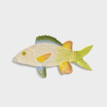 Decorative fish-shaped plate with a gradient of colors on a light gray background.