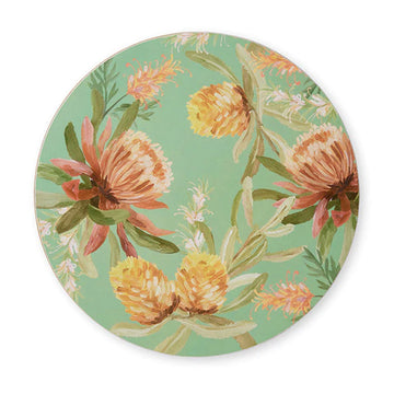 A round green place mat illustrated with brown flowers and leaves around the edge.