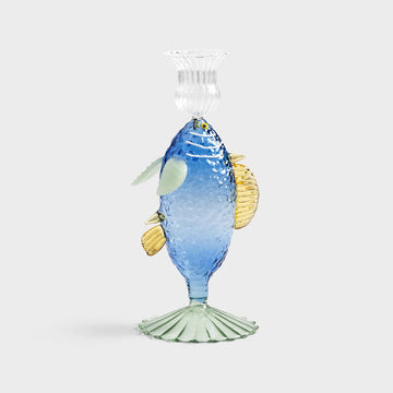 A fish shaped glass statue with a clear cup at the top for holding a candle.