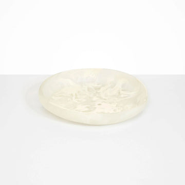 A large shallow bowl in a off white resin.