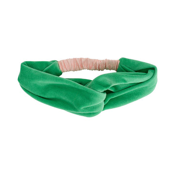 A velvet headband in green with a twist design.