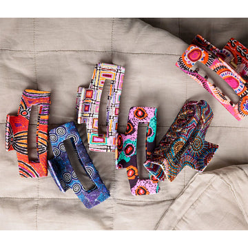 Six hair claws each printed with a different Indigenous artwork design.